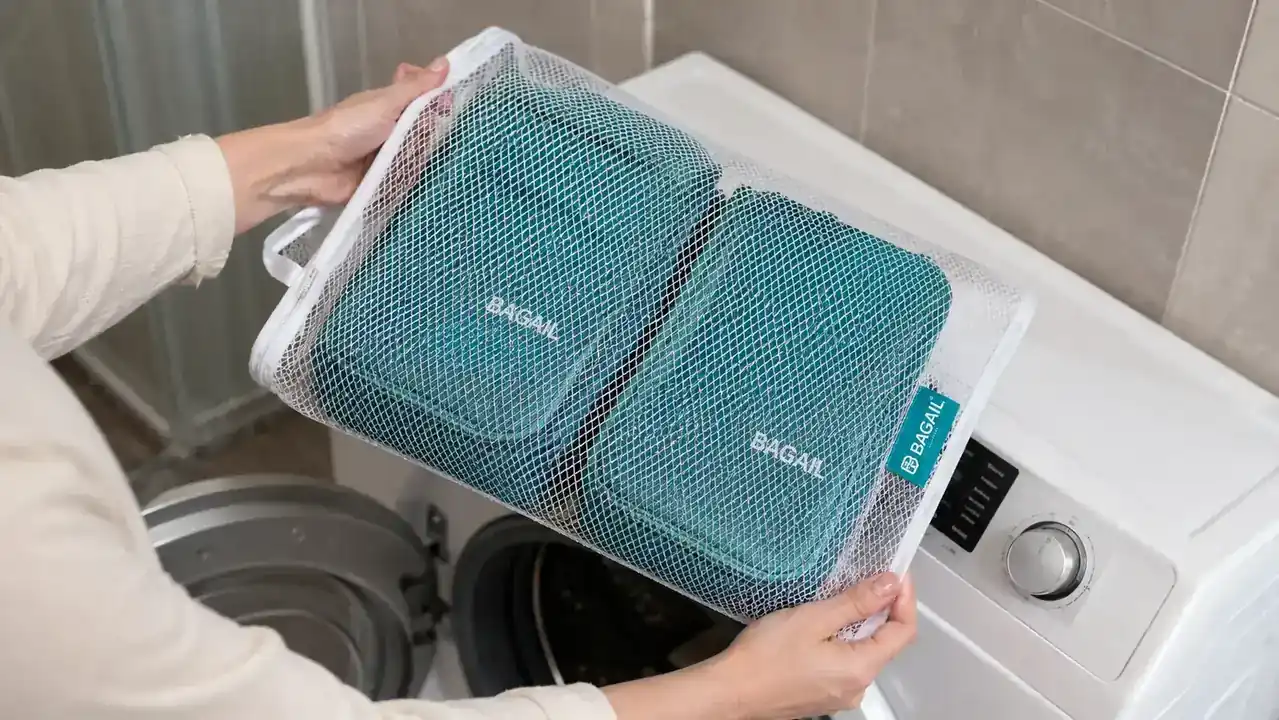 BAGAIL compression packing cubes in a mesh laundry bag ready to go into a washing machine