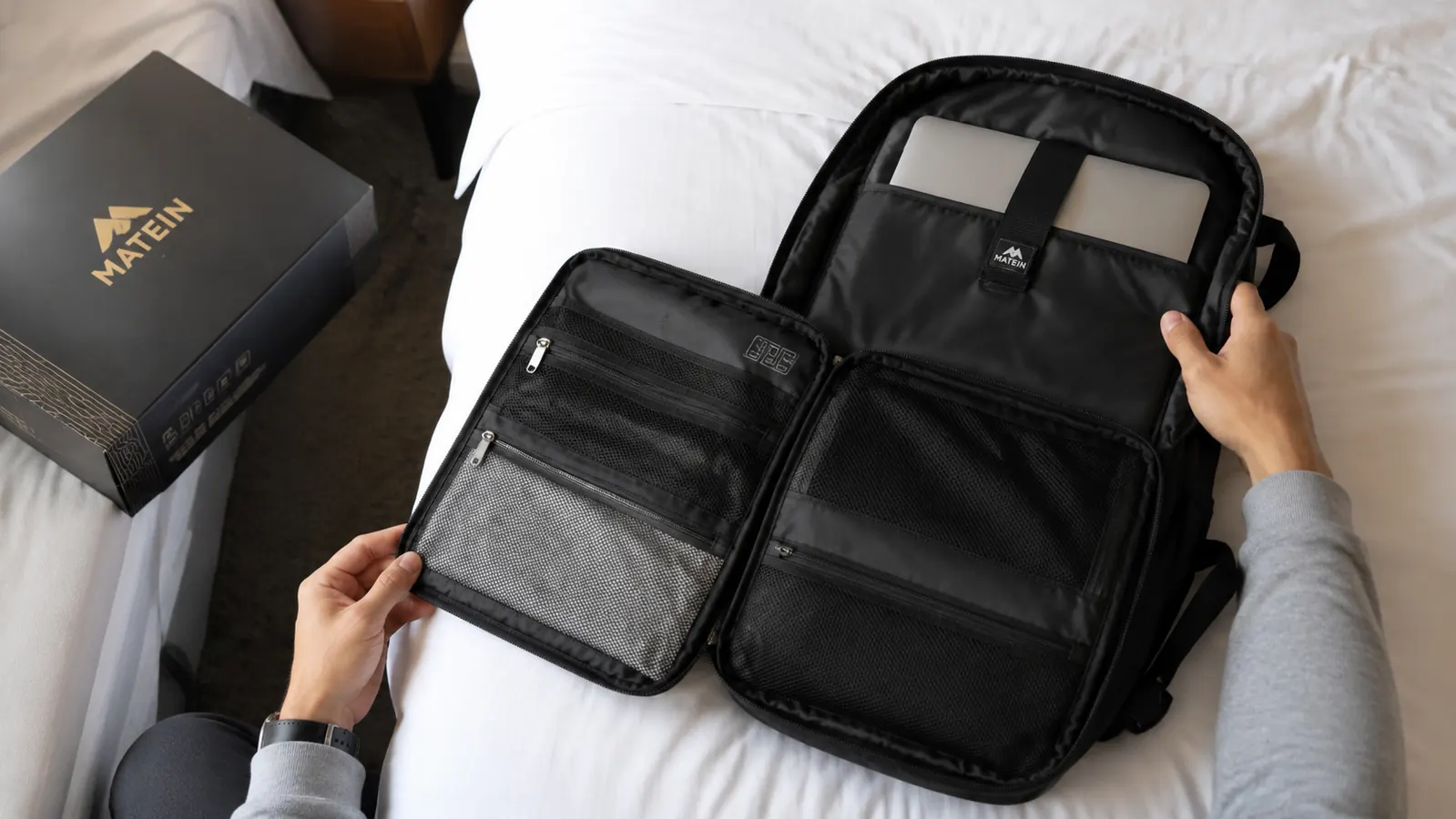 MATEIN backpack laid flat open showing organization pockets and laptop sleeve